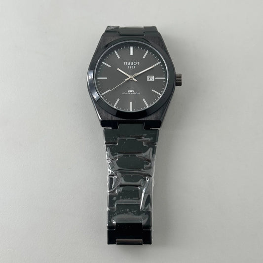 Black Tissot PRX Powermatic 80 wristwatch with stainless steel bracelet on white background