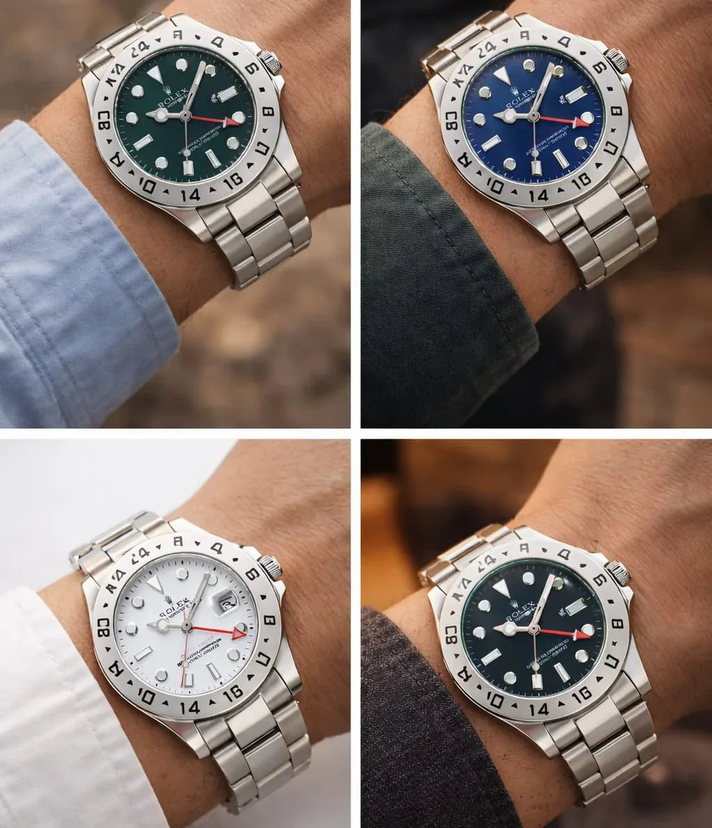 Men's stainless steel watches with colored dials and rotating bezels on wrists, close-up